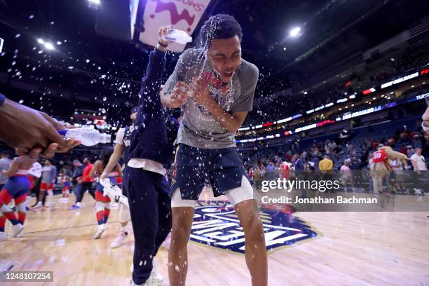 The New Orleans Pelicans dump water on Trey Murphy III of the New Orleans Pelicans after the game against the Portland Trail Blazers on March 12,...