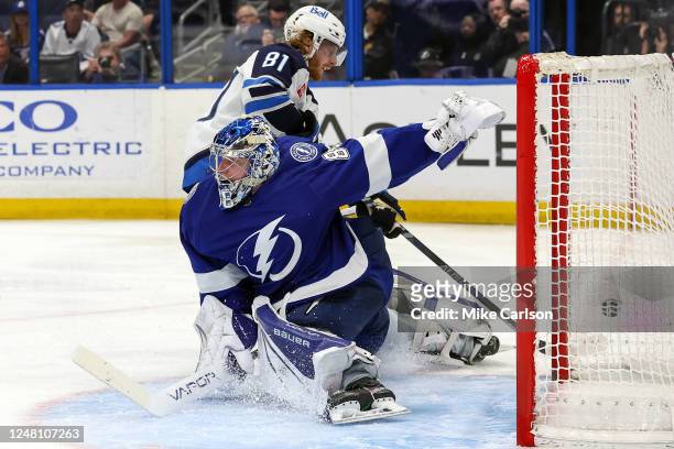 Andrei Vasilevskiy of the Tampa Bay Lightning makes a save against Kyle Connor of the Winnipeg Jets during the third period of a hockey game at the...