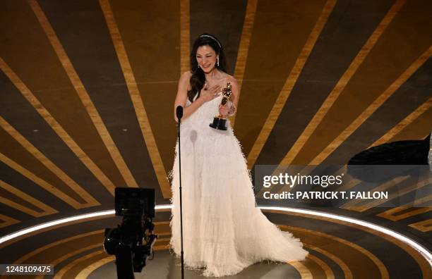 Malaysian actress Michelle Yeoh accepts the Oscar for Best Actress in a Leading Role for "Everything Everywhere All at Once" onstage during the 95th...