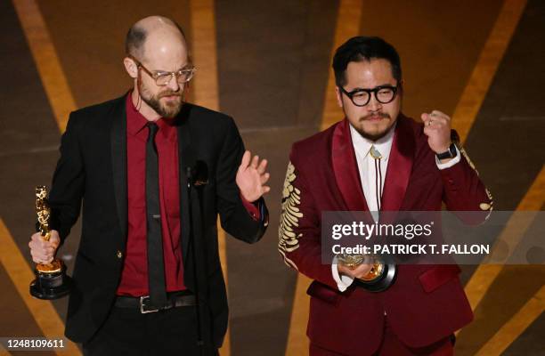 Director Daniel Scheinert and US director Daniel Kwan accept the Oscar for Best Director for "Everything Everywhere All at Once" onstage during the...