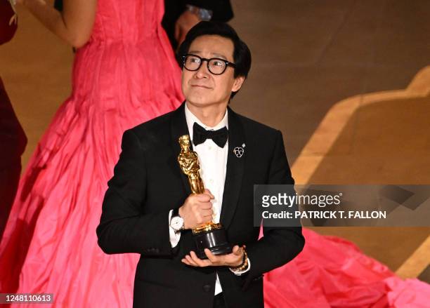Vietnamese actor Ke Huy Quan celebrates after winning the Oscar for Best Picture for "Everything Everywhere All at Once" onstage during the 95th...