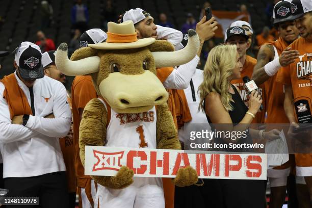 The Texas Longhorns mascot holds a sign saying Champs after the Big 12 basketball tournament championship game between the Texas Longhorns and Kansas...