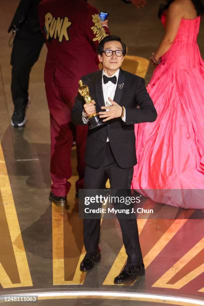 Ke Huy Quan takes a moment onstage after Everything Everywhere All at Once won Best Picture at the 95th Academy Awards in the Dolby Theatre on March...