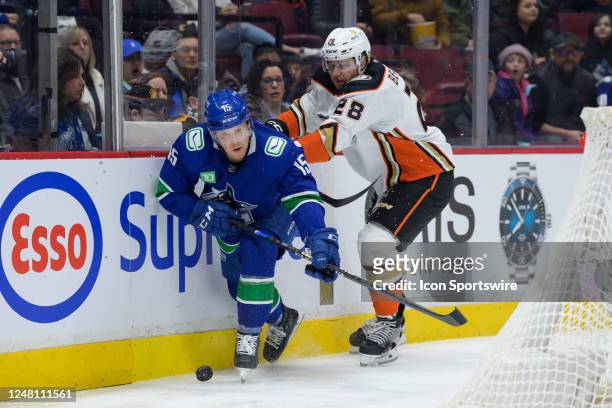 Vancouver Canucks center Sheldon Dries is checked by Anaheim Ducks defenceman Nathan Beaulieu during their NHL game at Rogers Arena on March 8, 2023...