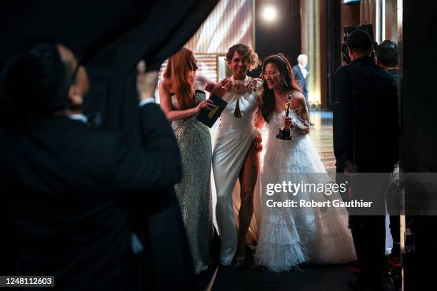 Michelle Yeoh, winner of the Best Actress award for "Everything Everywhere All at Once" walks backstage with Jessica Chastain and Halle Berry at the...