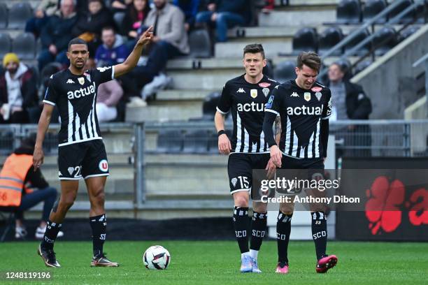 Cedric HOUNTONDJI of Angers Sco, Pierrick CAPELLE of Angers Sco and Adrien HUNOU of Angers Sco look dejected during the Ligue 1 Uber Eats match...