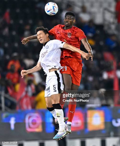 Wooyoung Jung of Al Sadd SC and Mohammed Muntari of Al Duhail SC battle for the ball during the QNB Stars League match between Al Sadd SC vs Al...