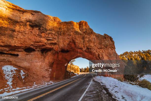 red arch road tunnel at bryce canyon national park - canyon utah stock pictures, royalty-free photos & images