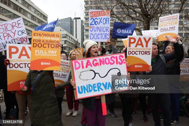 Junior doctors and supporters take part in a demonstration outside St Thomas' Hospital, during a strike over pay on March 13, 2023 in London,...