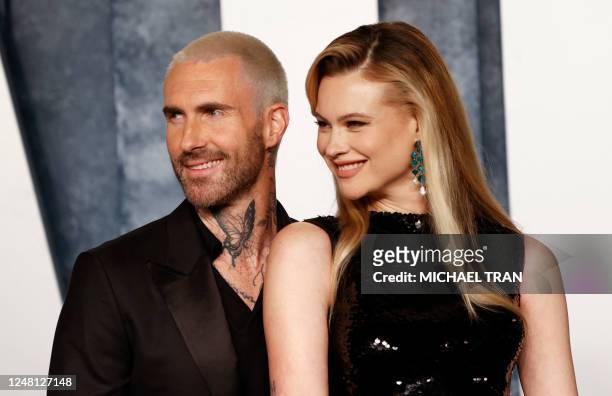 Namibian model Behati Prinsloo and husband singer Adam Levine attend the Vanity Fair 95th Oscars Party at the The Wallis Annenberg Center for the...