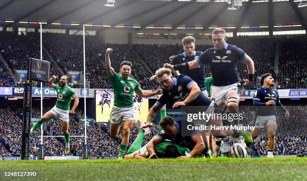 Scotland , United Kingdom - 12 March 2023; Jack Conan of Ireland scores his side's third try despite the tackle of Duhan van der Merwe of Scotland...