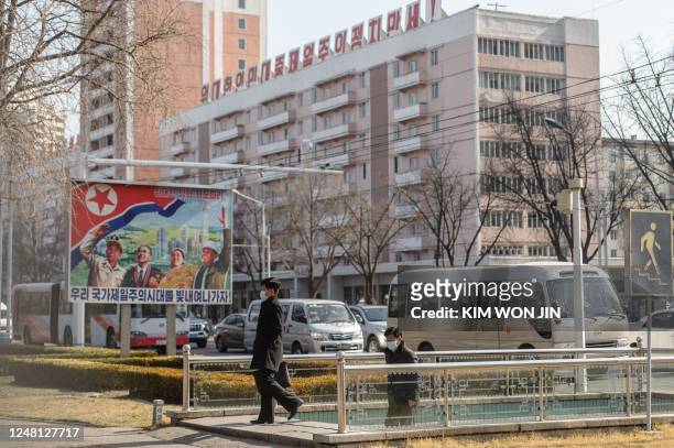 Pedestrians walk up a stairway in Pyongyang on March 13, 2023.