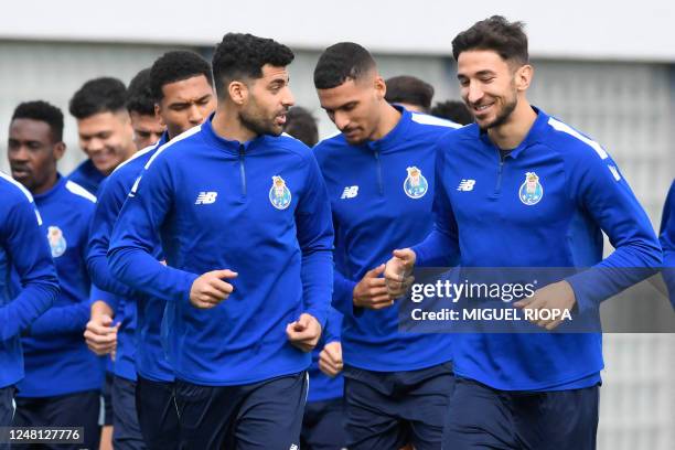 Porto's Iranian forward Mehdi Taremi and FC Porto's Serbian midfielder Marko Grujic attend a training session at the Olival training ground, in Vila...