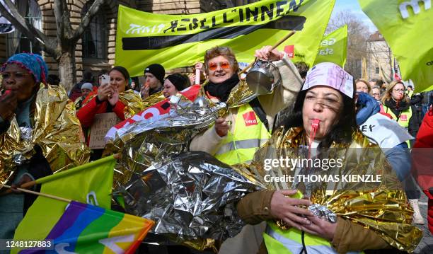 Employees of the public health care wearing first aid sheets take part in a protest rally during a warning strike in Stuttgart, southern Germany, on...