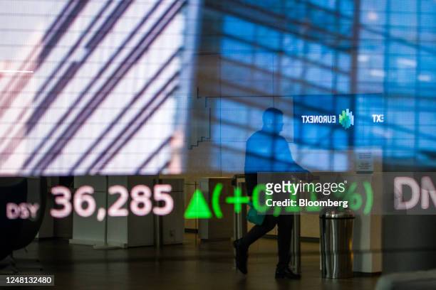 Stock price information reflected on a window at the Euronext NV stock exchange in Paris, France, on Monday, March 13, 2023. Investors poured money...