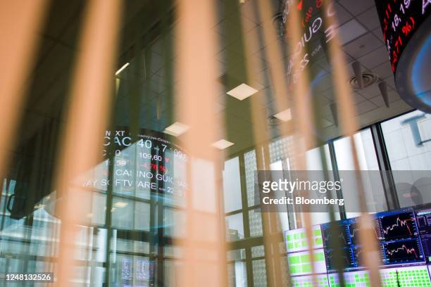 Stock price information reflected on windows on a trading floor at the Euronext NV stock exchange in Paris, France, on Monday, March 13, 2023....