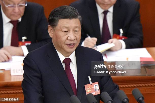 Chinese President Xi Jinping delivers a speech at the closing ceremony of the National People's Congress at the Great Hall of the People in Beijing...
