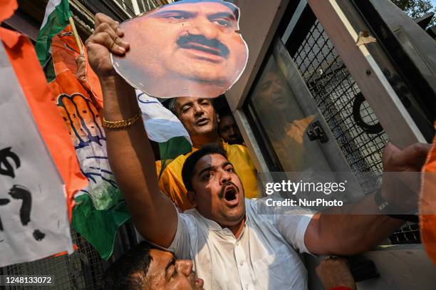 Activists of India's main opposition Congress party shout slogans as police detain them during a demonstration to protest against the Indian...