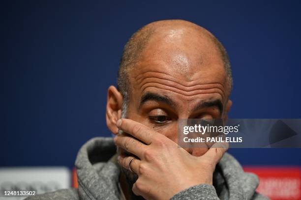 Manchester City's Spanish manager Pep Guardiola reacts as he attends a press conference at Manchester City training ground in Manchester, north-west...