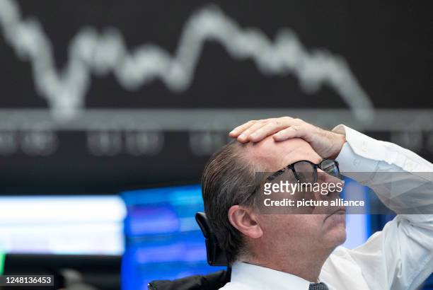 March 2023, Hesse, Frankfurt/Main: A stock exchange trader observes the price development at the German Stock Exchange in Frankfurt. The recent...