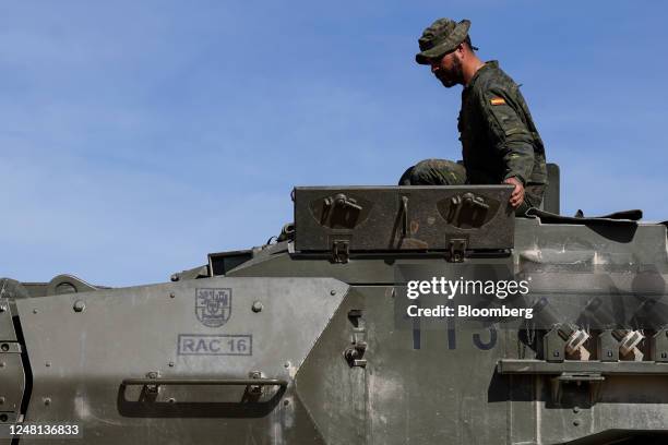 Member of the Spanish military climbs into the gun turret of a Leopard 2E tank during a training exercise for the Ukrainian military, at the San...