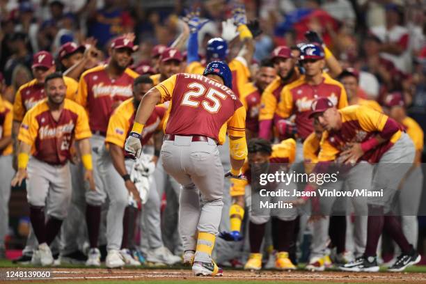 Anthony Santander of Venezuela celebrates with teammates at the plate after hitting a home run in the first inning against Puerto Rico at loanDepot...