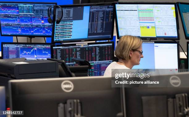 March 2023, Hesse, Frankfurt/Main: A stock exchange trader observes the price development at the German Stock Exchange in Frankfurt. The recent...