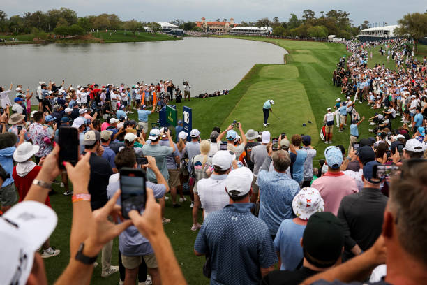 Scottie Scheffler plays his shot from the 18th tee during the final round of THE PLAYERS Championship at Stadium Course at TPC Sawgrass on March 12,...