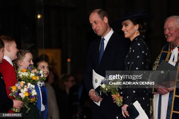Britain's Catherine, Princess of Wales and Britain's Prince William, Prince of Wales speak to altar boys as they leave Westminster Abbey, in London,...