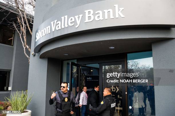 Security guards and FDIC representatives open a Silicon Valley Bank branch for customers at SVBs headquarters in Santa Clara, California, on March...