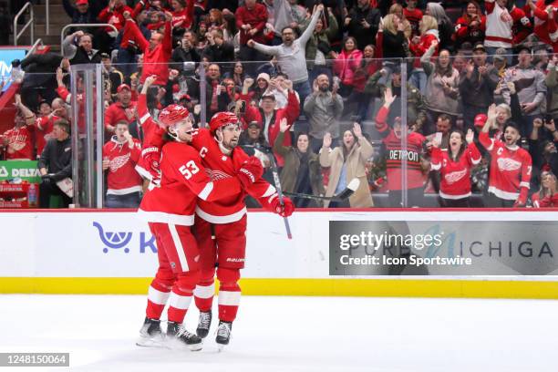 Detroit Red Wings forward Dylan Larkin celebrates his goal with Detroit Red Wings defenseman Moritz Seider while fans cheer in the background during...