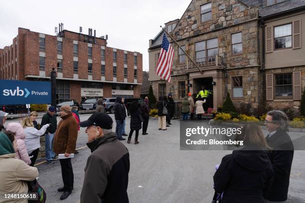 Customers wait in line outside of a Silicon Valley Bank branch in Wellesley, Massachusetts, US, on Monday, March 13, 2023. The collapse of Silicon...