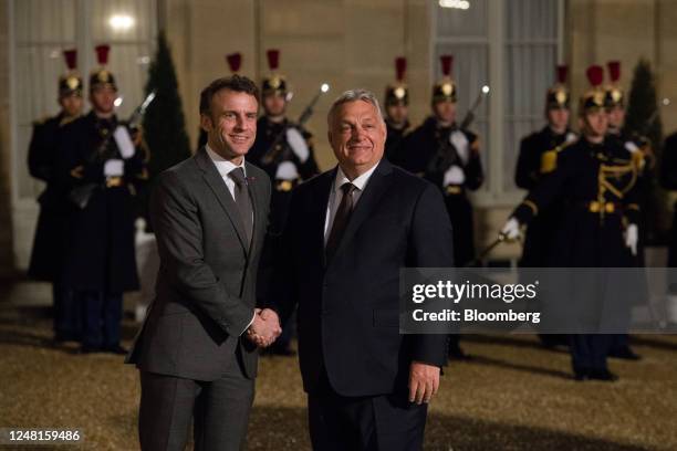 Emmanuel Macron, France's president, left, welcomes for Viktor Orban, Hungary prime minister, ahead of their working dinner at the Elysee Palace in...