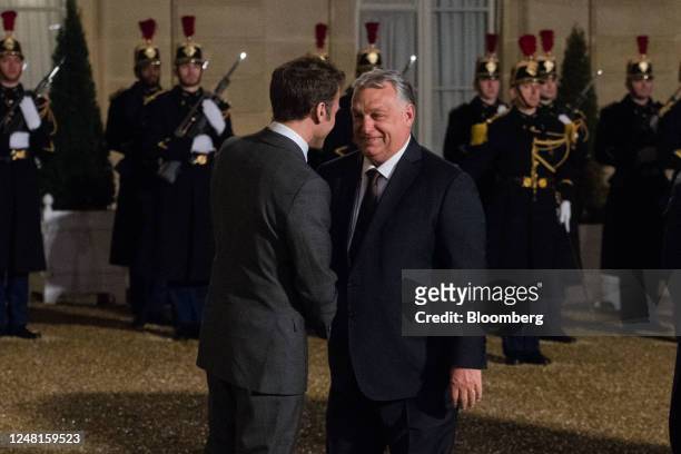 Emmanuel Macron, France's president, left, welcomes for Viktor Orban, Hungary prime minister, ahead of their working dinner at the Elysee Palace in...