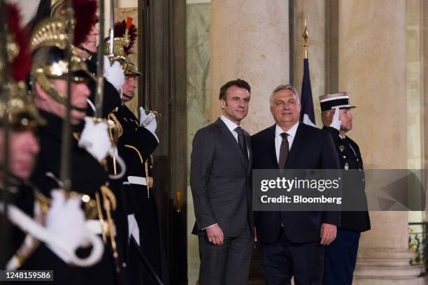 Emmanuel Macron, France's president, left, welcomes for Viktor Orban, Hungary prime minister, ahead of their working dinner at the Elysee Palace in...