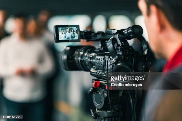 close-up of cameraman filming in studio - filming stock pictures, royalty-free photos & images