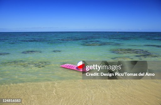 Pink Inflatable Raft Pink Inflated Raft And Beachball On Clear Ocean Water High-Res Stock ...