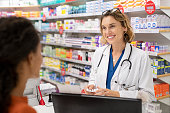 Pharmacist giving medicine to customer