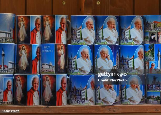 Mugs for sale with the image of Pope John Paul II in the souvenir shop in the Cloth Hall, in Krakow, Poland, on March 13, 2023. A controversial...