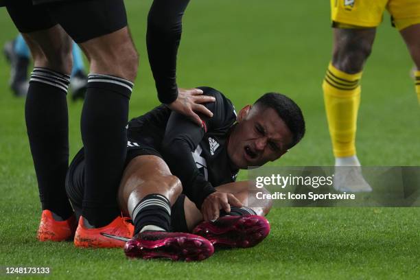 Andy Najar of D.C. United holds his ankle while his lays on the found during the second half between the the Columbus Crew and the D.C. United at...