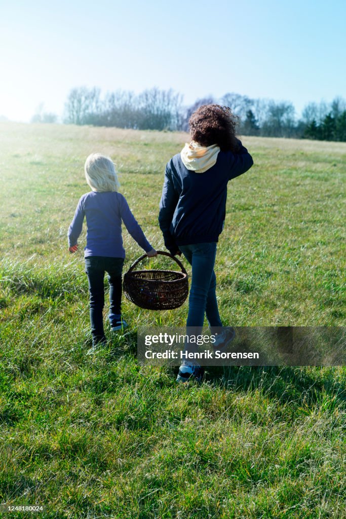 2 girls walking on gras field