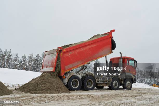 construction of a new road in siberia - dumper truck foto e immagini stock