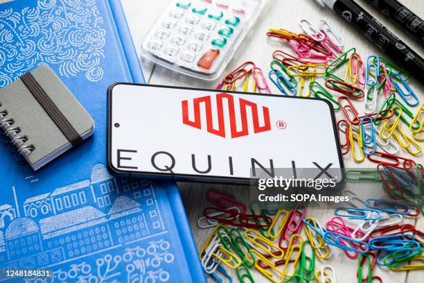 In this photo illustration a Equinix logo seen displayed on a smartphone.