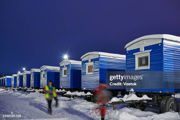 a village of trailers for workers building a new road in siberia - mobile home stock-fotos und bilder