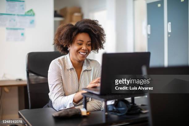 businesswoman making a video call in office - woman business desk front laptop office bildbanksfoton och bilder