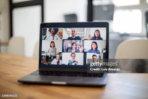 colleagues having a work meeting through a video call - laptop imagens e fotografias de stock