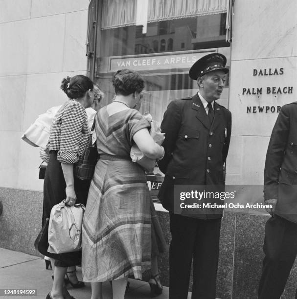Shop security guard outside the Van Cleef & Arpels jewellery store on Fifth Avenue, New York City, circa 1952.