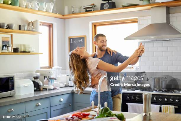 coppia romantica che balla in cucina a casa - couple in kitchen foto e immagini stock