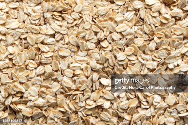 oat flakes background - oats stock-fotos und bilder