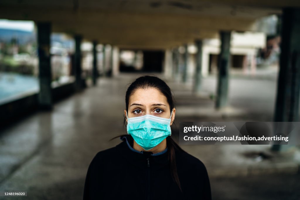 Scared sick woman wearing protective mask.Suffering from infectious disease.Infected patient suffering from symptoms of illness.Panic and fear of infection.Life in contaminated area.Nosophobia